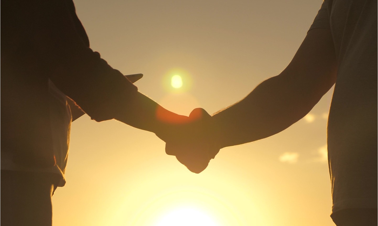 Weller Insurance | silhouette of handshake in front of sunset