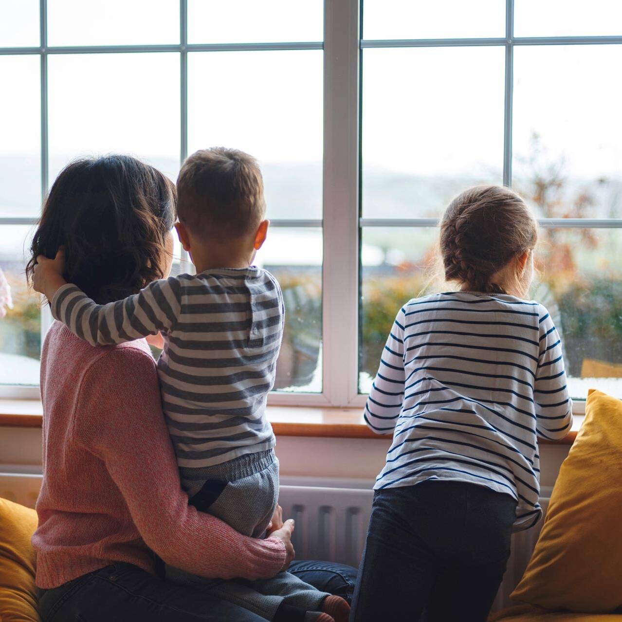 Weller Insurance | mother and two children looking out window